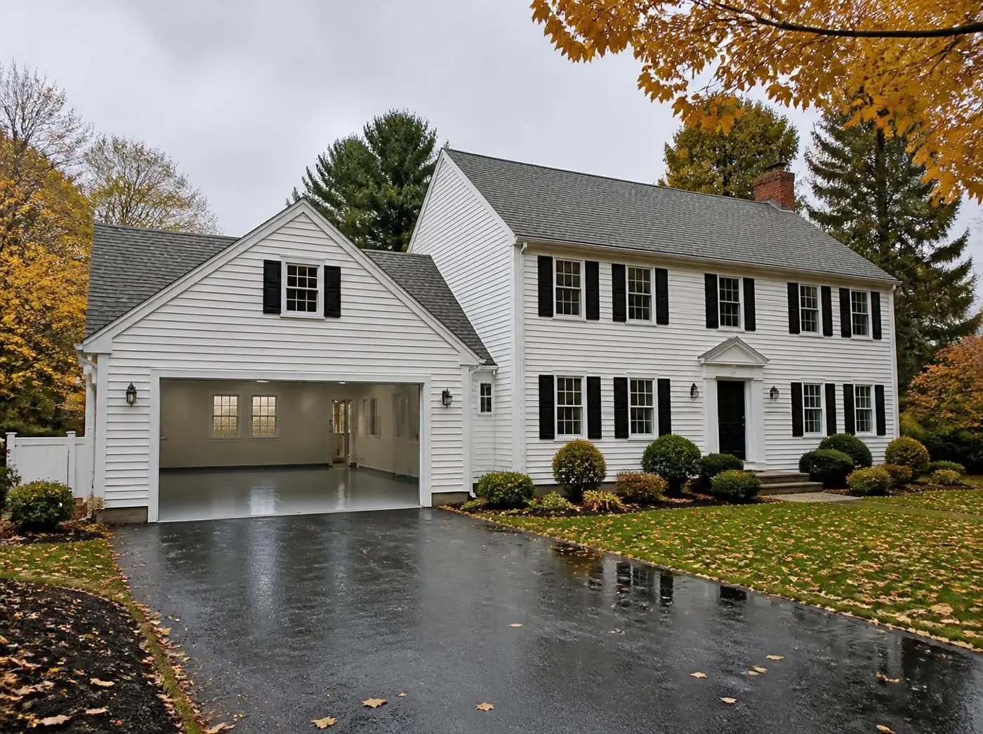 New England colonial home with an attached two-car garage and coated floor
